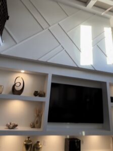 Discover how custom wall transformation with built-in shelving, adjustable LED lighting, and precision drywall finishing creates architectural focal points. Professional carpentry from studs out in Central Indiana.