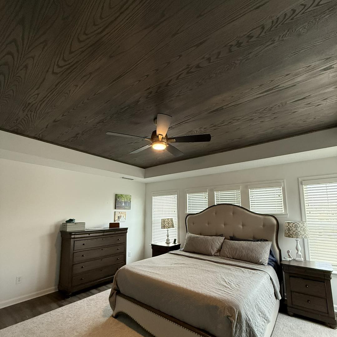 A tongue-and-groove ceiling built from custom-milled Indiana red oak — installed tight, stained to match the home's interior, and finished at the highest level. See what true custom woodwork looks like.