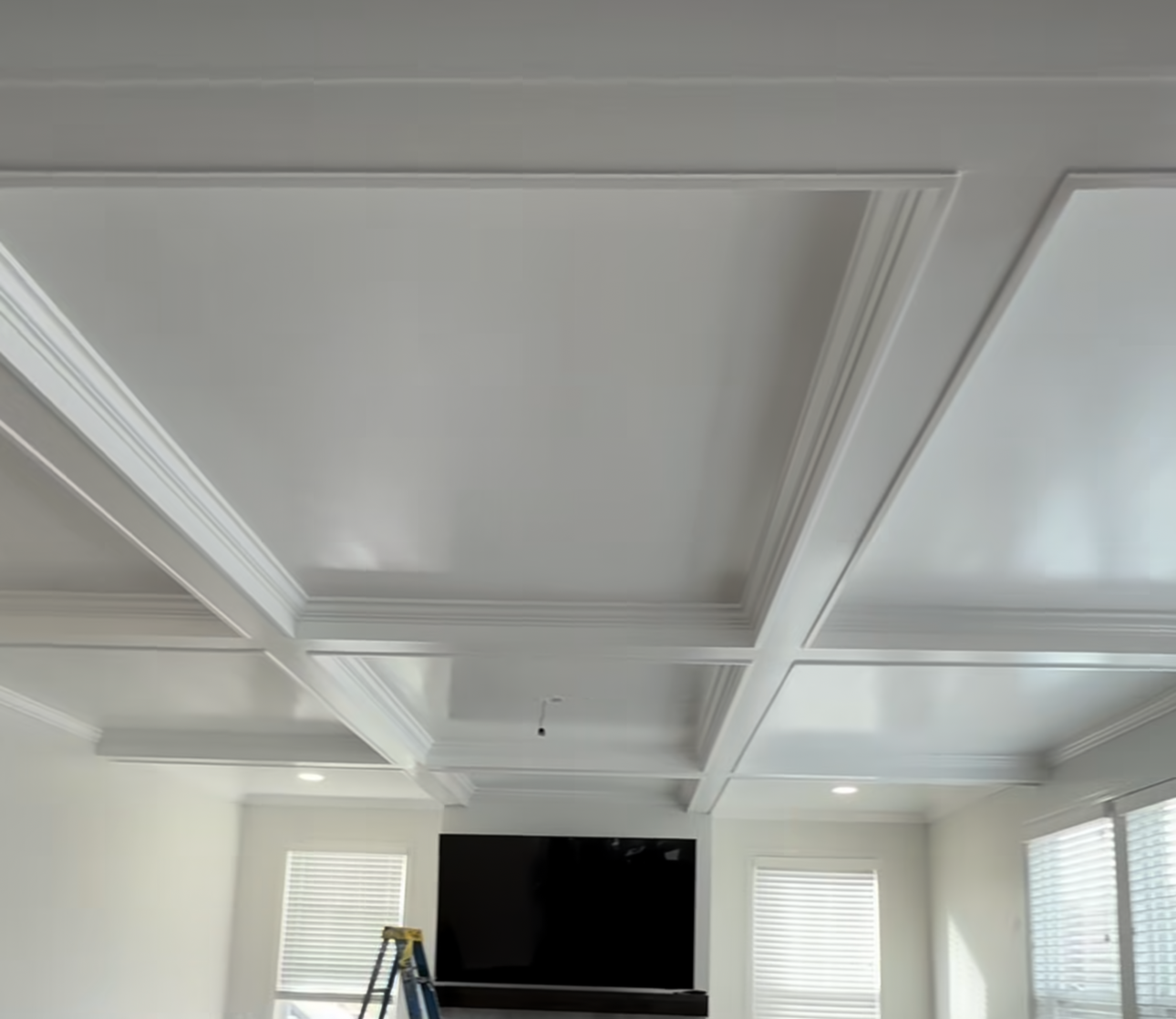 A coffered ceiling project that hit an unexpected water line turned into one of our best builds — smooth finish, recessed lighting, and a layout that looks original to the home. Here's how it came together.