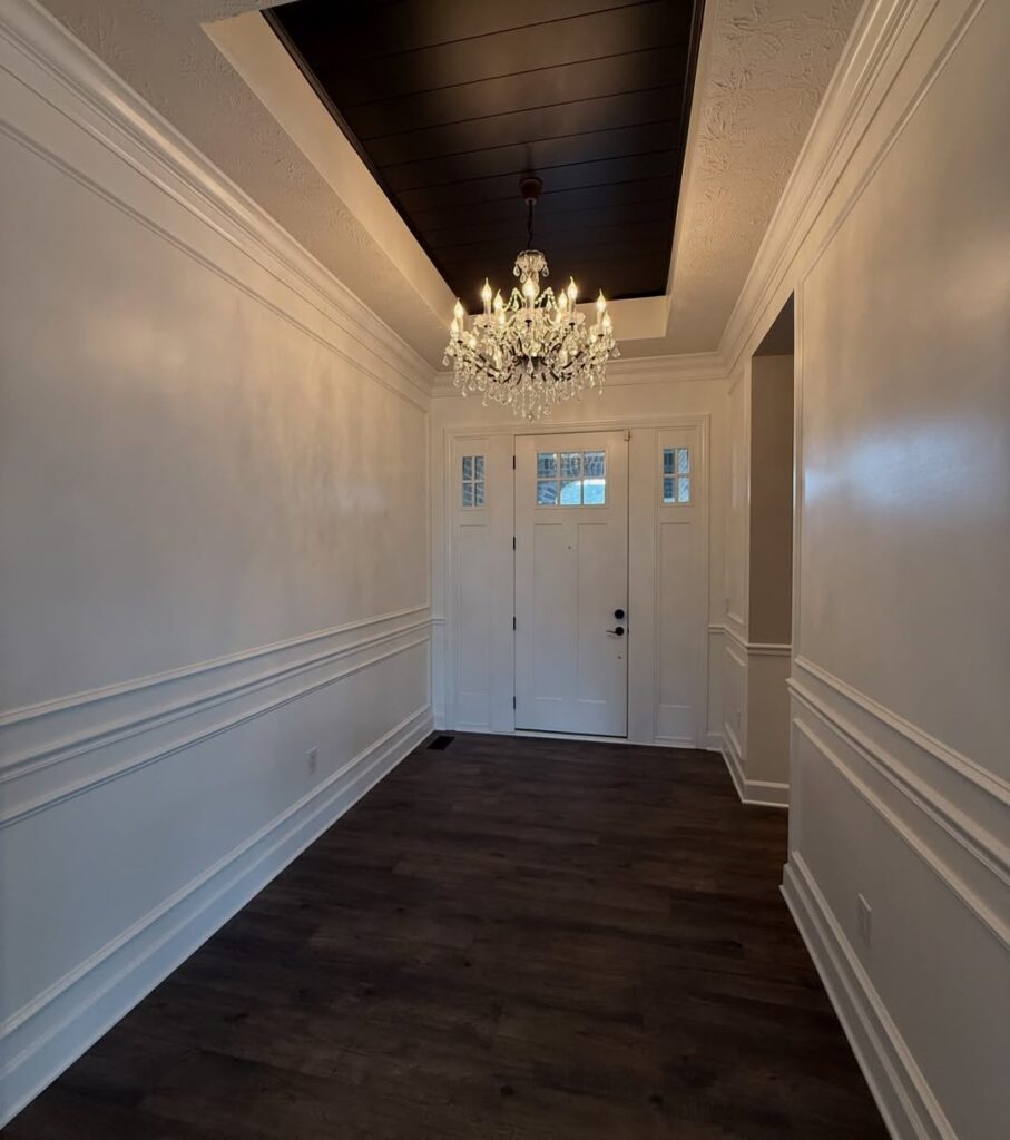 An entryway transformed with a black shiplap ceiling, custom picture frame molding, and wainscoting carried through the hallway at the right height. See how Radford Woodworks turned a Carmel, Indiana home into something truly unforgettable.