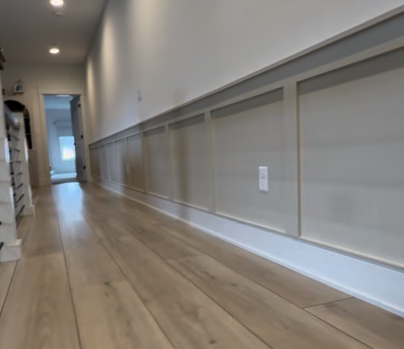 Accent wall design can turn a long blank walkway into one of the strongest features in a home with clean trim carpentry, balanced layout, professional painting, and custom finish work.