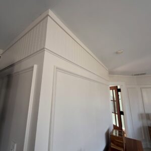 Molding brings quiet character to a primary suite through picture frame detail, beadboard, cove molding, trim carpentry, accent walls, and custom finish work.