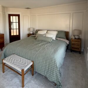 Molding brings quiet character to a primary suite through picture frame detail, beadboard, cove molding, trim carpentry, accent walls, and custom finish work.