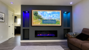 Indiana electric fireplaces trend: charcoal media wall with a frame-style TV, lighted recessed niches, and a linear fireplace with a blue ember bed