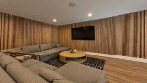 Indiana Wall Paneling - Vertical red oak slat wall with warm amber grain in the main living space of a Chatham Hills home in central Indiana